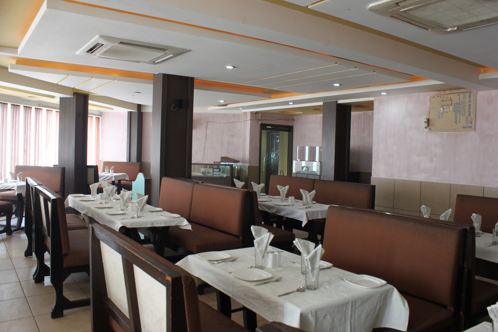 White-tablecloth dining tables with wooden booth seating