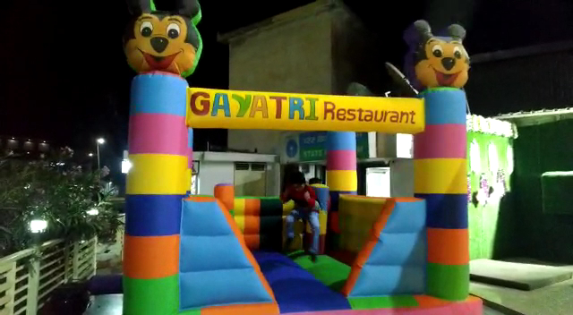 Outdoor family area with bounce house and welcome desk